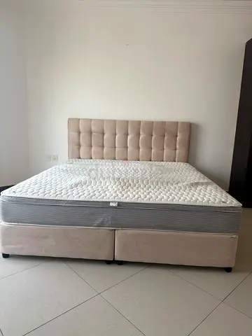 Queen upholstered bed frame with mattress and tufted headboard