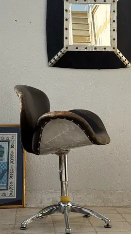 Brown leather and aluminum swivel chair