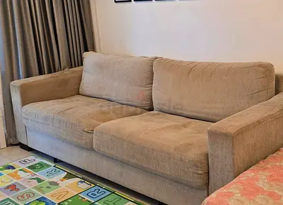 4-seater beige fabric sofa bed from Home Centre for sale