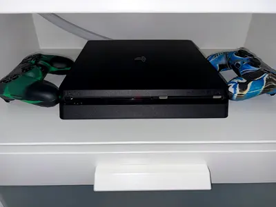 PS4 Slim with 2 DualShock controllers and 6 games