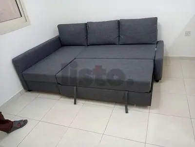 Gray L-shaped sofa bed with storage — good condition