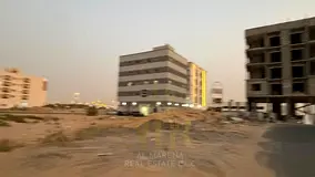 A residential/commercial plot of land in Al Alia, Ajman, measuring 4300 sq ft, with a building permi