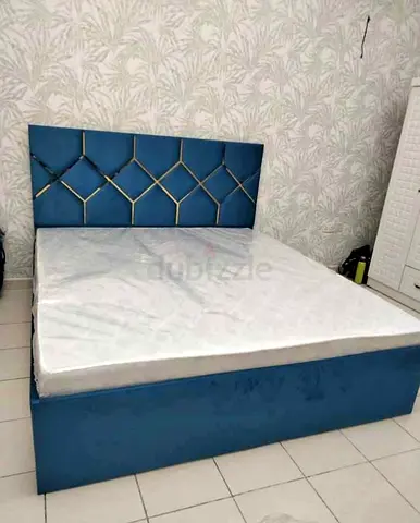 Blue upholstered double bed with and mattress