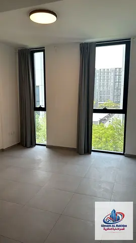 Luxury apartment in Aljada with a spacious bedroom, panoramic living room, modern kitchen, 2 bathrooms, central AC and gas, plus pool, gym and parking