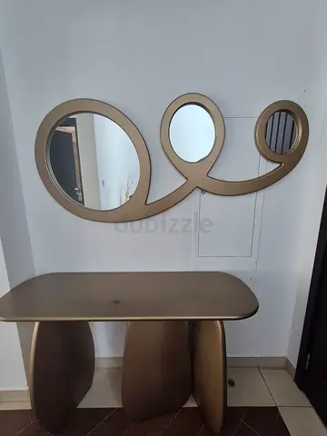 Gold three-piece hall console table with matching decorative mirrors