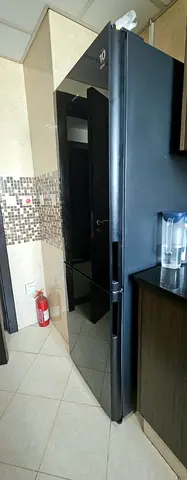 Sparingly used Hitachi black gloss finish refrigerator is excellent condition.