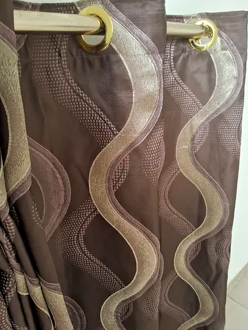 Pair of brown wave-patterned eyelet curtains (ready to hang)