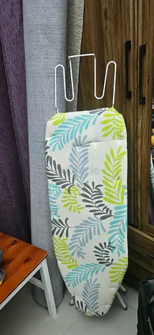 Ironing board with patterned cover - good condition