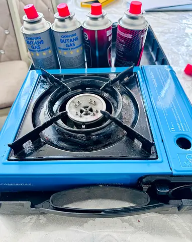 Portable single-burner butane gas stove with cartridges - used