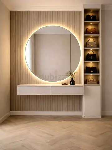 Wall-mounted vanity console with illuminated round mirror and shelving