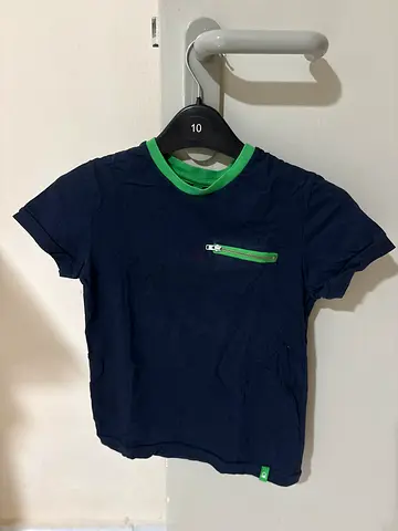 Navy blue kids T-shirt with green trim and front zipper pocket -