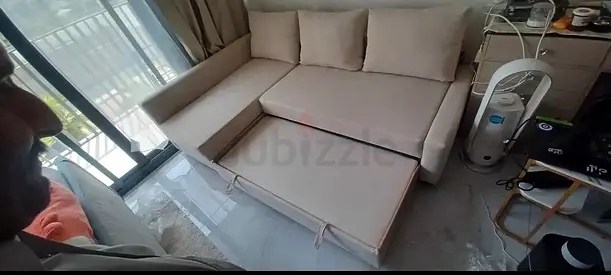 Beige L-shaped Sofa Bed with Storage - Good Condition