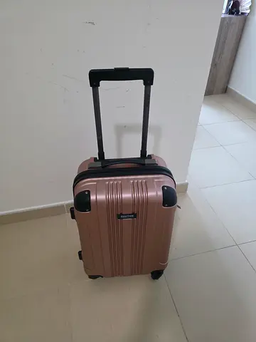 Rose gold Kenneth Cole 20" hard-shell carry-on suitcase with telescopic handle and wheels