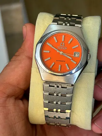 vintage Titus Automatic wristwatch with a striking orange dial and a stainless steel case and bracel