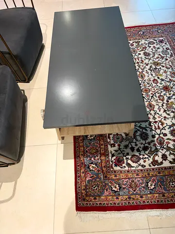 Modern grey coffee table with two velvet stools and Persian-style rug (used)
