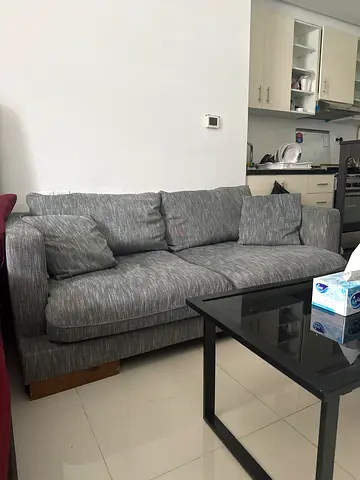 Grey fabric two seater sofa with black coffee table