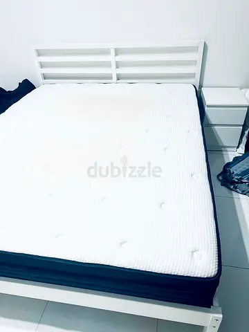 White wooden double bed frame with mattress and bedside drawer - good condition