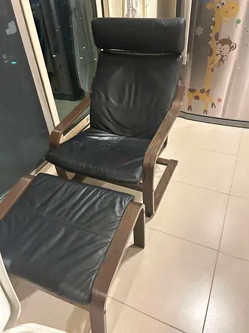IKEA Poäng-style black leather recliner with matching footstool