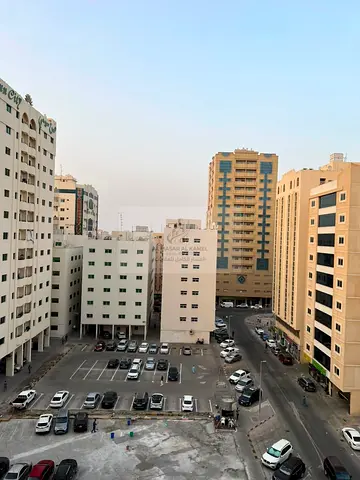 One-Bedroom Apartment for Annual Rent in Al Qasimia Al Mahatta Directly Opposite the Park with Balcony, Large Spaces, Distributor and One Free Month