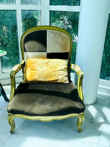Vintage-style upholstered armchair with carved wooden frame