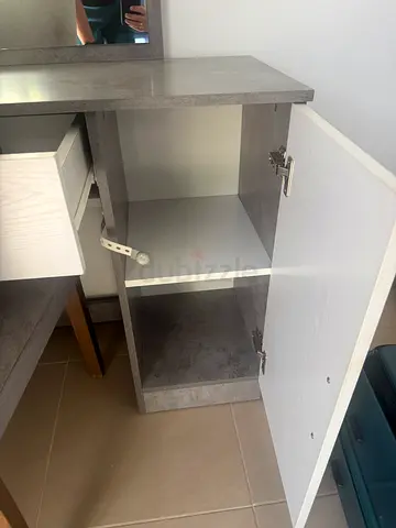 Small two-door storage cabinet with interior shelf - light grey finish