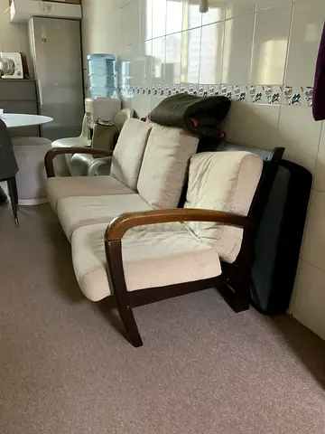 Wooden frame armchair with beige cushions - good condition