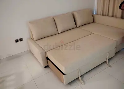 Beige L-Shaped Sofa Bed with Pull-Out Section