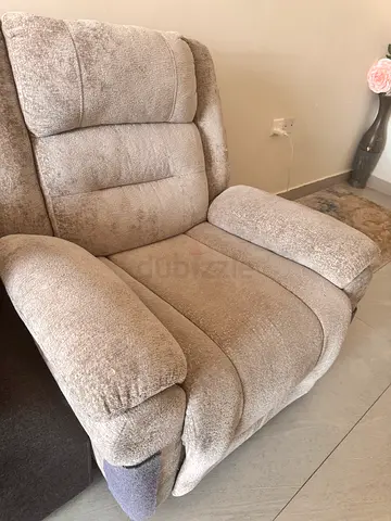 Single beige fabric recliner chair — good condition
