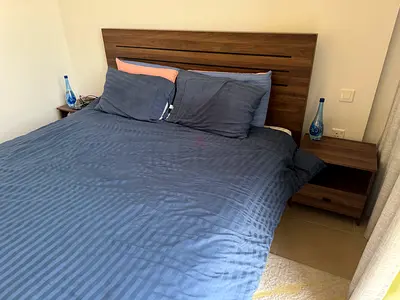 King size 200x180 wooden bed frame with headboard and matching bedside tables and IKEA mattress