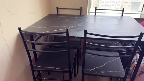 Black faux-marble dining table with 4 metal chairs - good condition