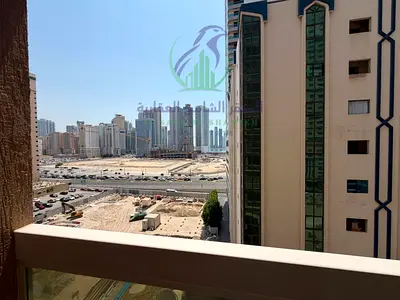 Spacious 2BR apartment for annual rent with master bedroom, balcony, built-in wardrobes, modern finishing, and flexible payment in 4 cheques.