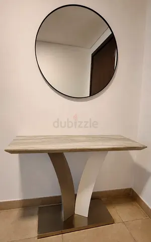 Modern stainless steel console table with marble top and round wall mirror