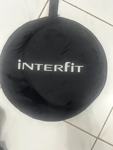 Interfit collapsible photographic reflector with its original carrying case.