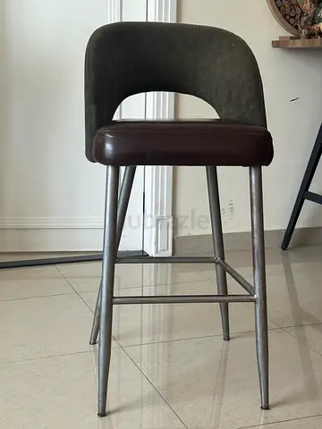 Industrial metal bar stool with brown padded seat