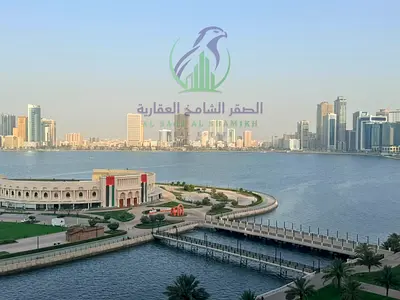2BR apartment for annual rent in Al Majaz 3, Al Owais, featuring a stunning sea view, two balconies, laundry room, built-in wardrobes, and parking
