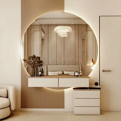 Modern round backlit wall mirror with floating vanity shelf and drawer unit