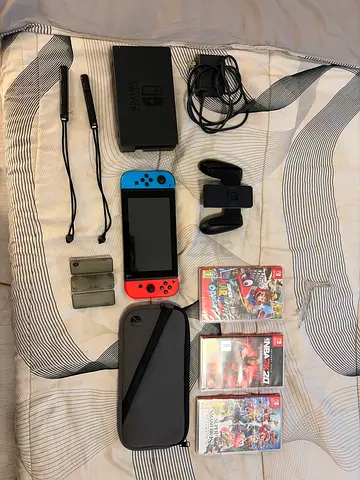 Nintendo Switch console with Joy‑Cons, dock, case, game holder and 3 games (good condition)