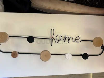 Wall-mounted 'home' coat rack with wooden knobs