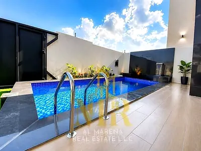 **Special Offer – Includes All Registration and Ownership Fees!** **Luxury Modern Villa for Sale in Al Zahia – Ajman (Swimming Pool and Spacious Yard)