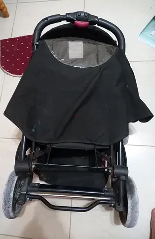 Used black double stroller in good working condition