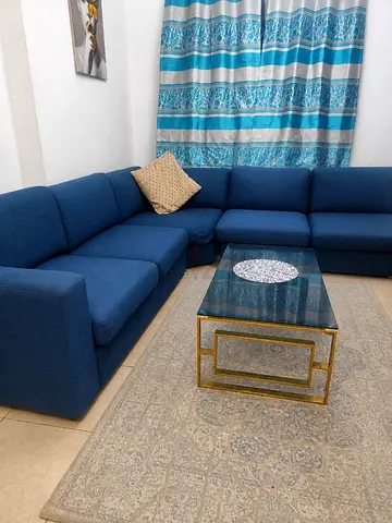 Blue L-shaped Fabric Corner Sofa - Good Condition with Coffee Table and Carpet