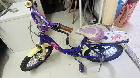Child's purple 16-inch girls bike with training wheels