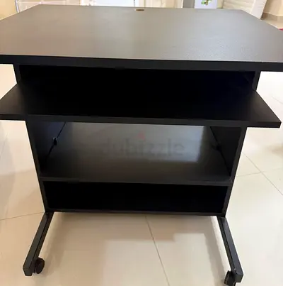Small black computer desk with pullout for keyboard on wheels and computer chair