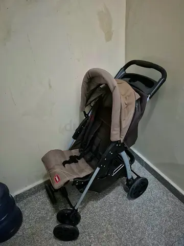 Lightweight beige baby stroller in good condition. Foldable