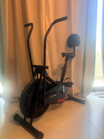 Used air fan bike with dual-action arms and padded seat
