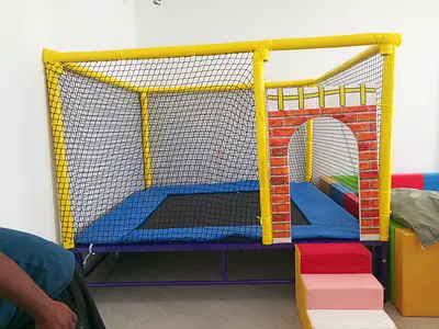 Indoor soft play trampoline with safety net and crawl tunnel