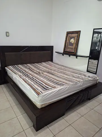 King-size wooden platform bed with headboard and side storage