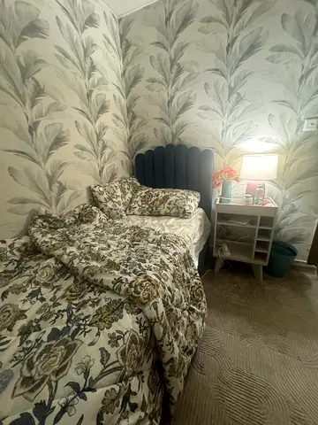 Blue bed with headboard and bedside shelf