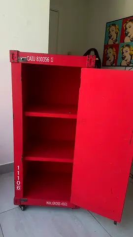 Red wooden storage cabinet on wheels — industrial style, good condition