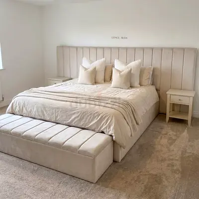 Large upholstered king bed with tall panel headboard